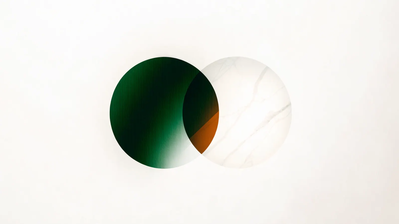 Two overlapping translucent circles, one green and one stone, with an amber sliver where they meet