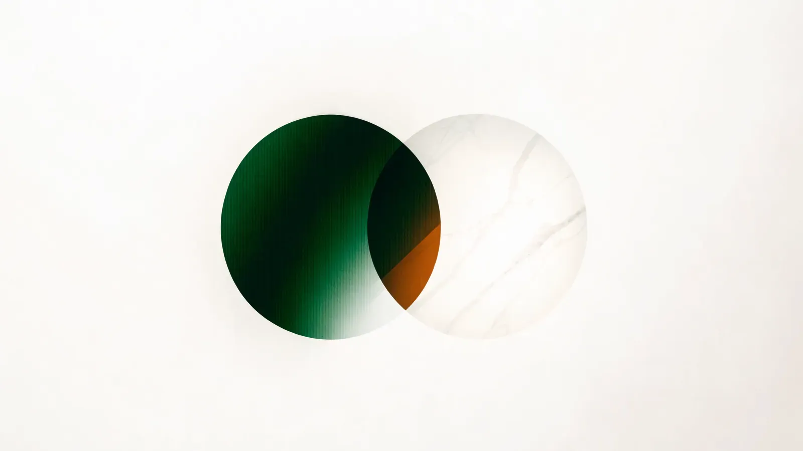 Two overlapping translucent circles, one green and one stone, with an amber sliver where they meet